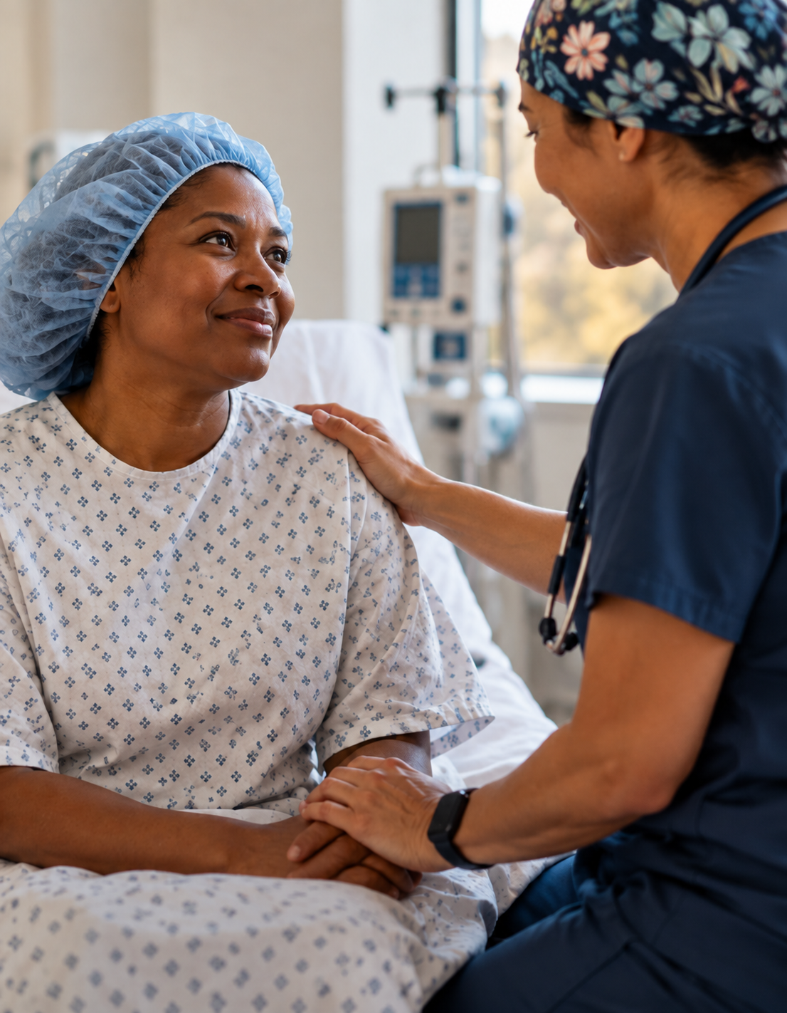 A clinician holding a patient’s hand in a hospital room